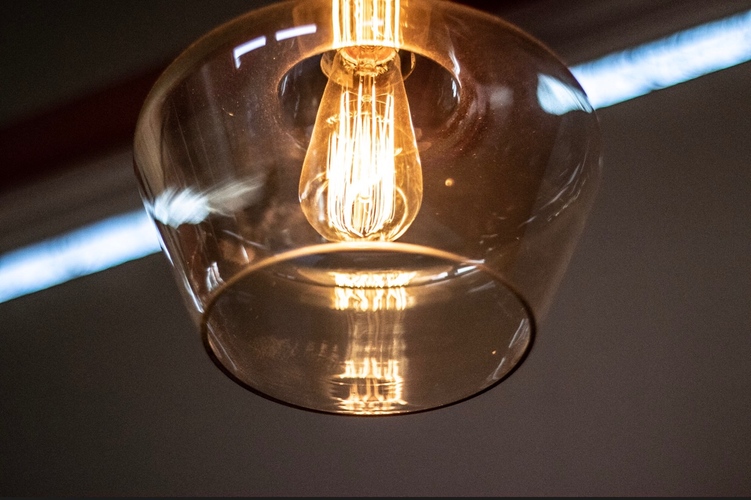 Artistic photo of one of the large ceiling lights and bulb.