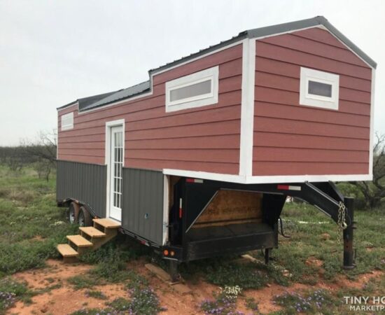 A gooseneck tiny house from Breckenridge, Texas with three windows to the front and side and a windowed single front door.