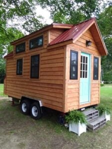 External view of this tiny house on a trailer (from Lancaster, South Carolina, based off the 'Tiny Living' plans), showing 6 windows and the windowed front door.