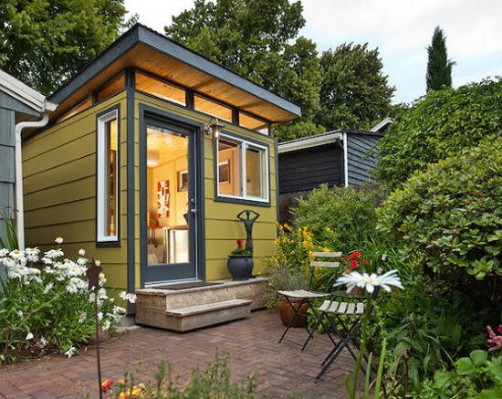 Modern-Shed's small shed which can be effectively used as a backyard studio; it has lots of windows for natural light, and inside lights to produce a well-lit (and easy to work in) space.