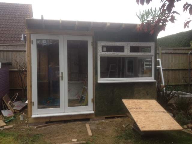 A work in progress photo of Roger Perkin's garden office shed, with UPVC doors and windows added. Roof and internals still need finishing off.