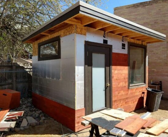 1 inch foam insulation and then stained-red cedar wood attached to the wood sheathing outside the backyard office, from Mr Money Mustache.