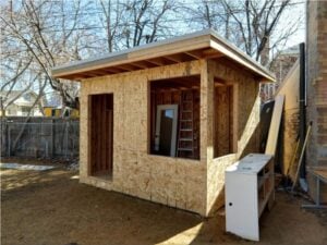 OSB wall sheathing on the front and side of the backyard office shed