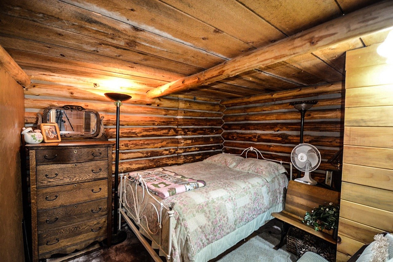 A photo showcasing a bed in a tiny house