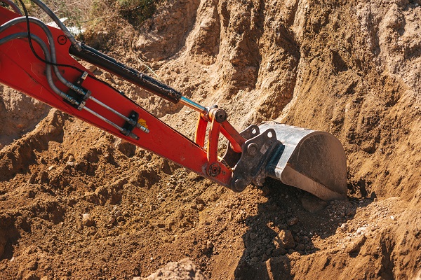 Excavator shovel digging on dirt